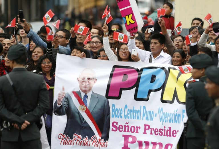 People wait for President Pedro Pablo Kuczynski at the National Congress in Lima on July 28, 2016