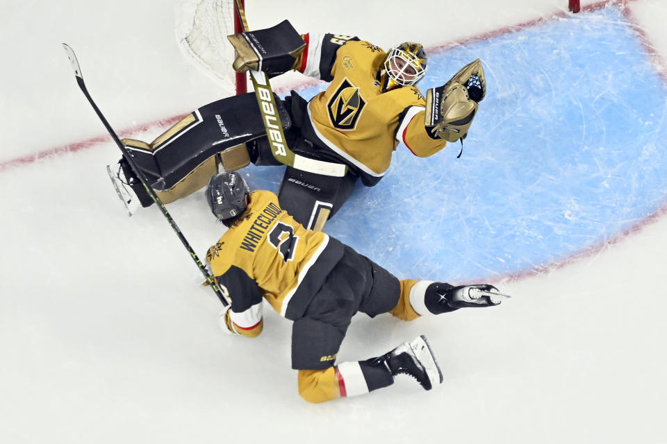 Vegas Golden Knights goaltender Laurent Brossoit (39) makes a save against the Winnipeg Jets with defenseman Zach Whitecloud (2) nearby during the third period of Game 5 of an NHL hockey Stanley Cup first-round playoff series Thursday, April 27, 2023, in Las Vegas. The Golden Knights won the series. (AP Photo/David Becker)