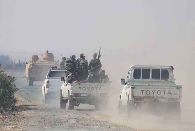 Turkey-backed Syrian rebels drive near the border town of Tal Abyad