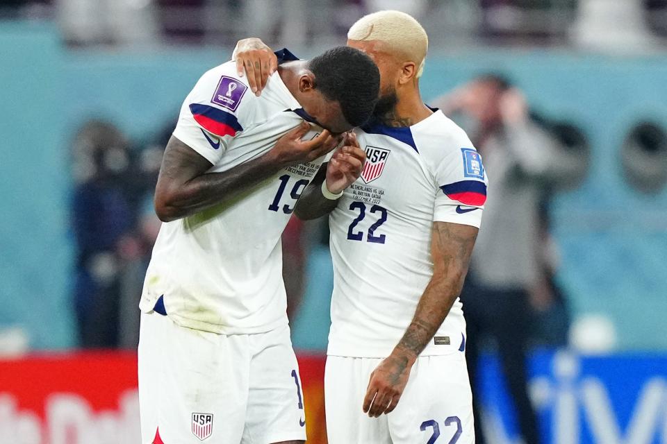 DeAndre Yedlin (22), the only USMNT player with World Cup experience entering Qatar, consoles Haji Wright after losing a round of sixteen match against the Netherlands in Khalifa International Stadium.