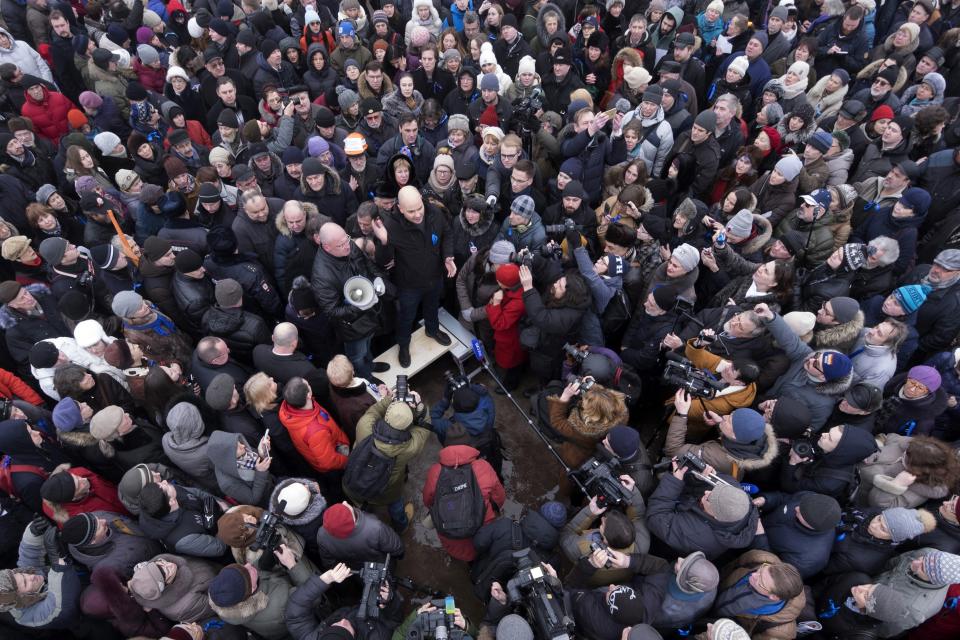 FILE - Andrei Pivovarov, center, speaks during a protest rally against the transfer of St. Isaac's Cathedral to the Russian Orthodox Church in St.Petersburg, Russia on Jan. 28, 2017. Pivovarov, former head of the Open Russia group, was sentenced to four years in prison for "directing an undesirable organization," a criminal offense under a 2015 law. His allies say he is being transferred to a prison to serve his sentence, and his whereabouts have remained unknown for a month. (AP Photo/Dmitri Lovetsky, File)