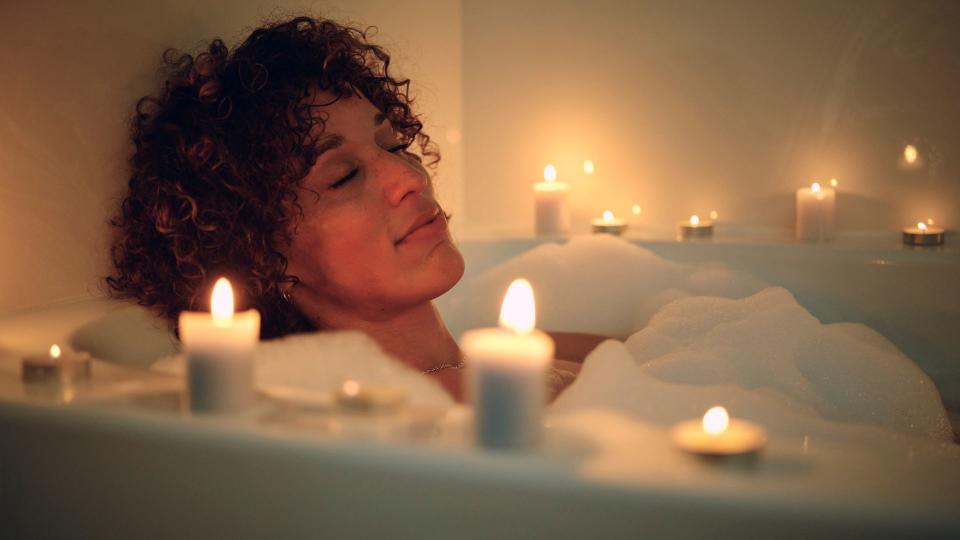 Woman taking a bath by candle light