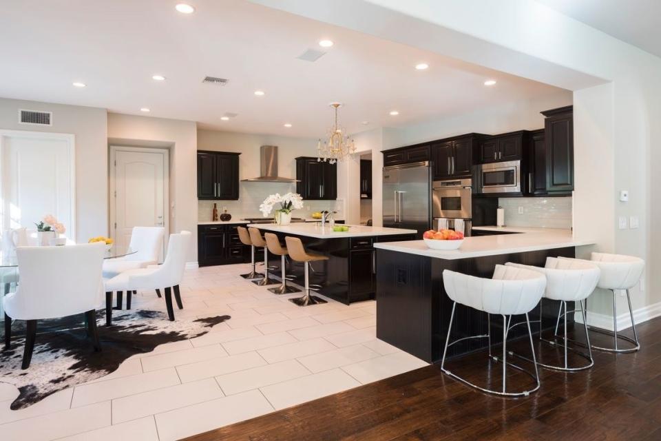 The black-and-white kitchen features multiple dining areas.