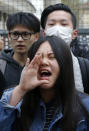 Demonstrators from the Asian community protest outside Paris' 19th district's police station, Tuesday March 28, 2017. Violent clashes in Paris between baton-wielding police and protesters outraged at the police killing of a Chinese man in his home have seen three police officers injured and 35 protesters arrested, authorities said Tuesday. (AP Photo/Michel Euler)