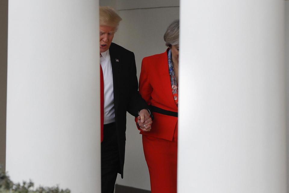 Hand-holding: Donald Trump and Theresa May hold hands as they walk to the press conference. (AP)