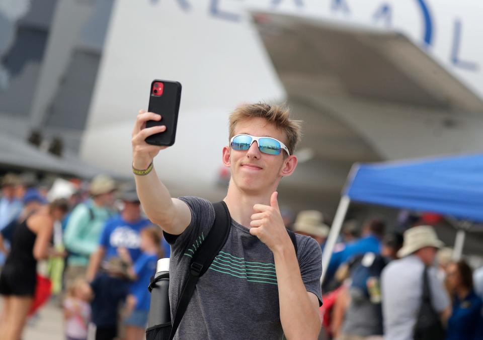 Lucas Rebro takes a selfie in front of the Boeing Dreamlifter 747-400 Large Cargo Freighter during EAA AirVenture Oshkosh 2023 on Monday, July 24, 2023 in Oshkosh, Wis. Wm. Glasheen USA TODAY NETWORK-Wisconsin