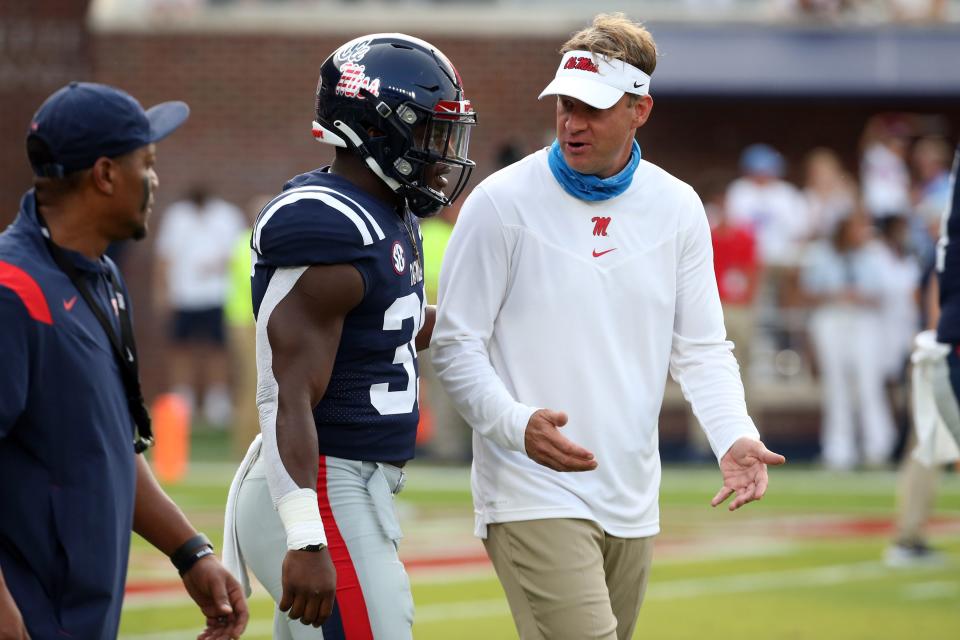 Sep 11, 2021; Oxford, Mississippi, USA; Mississippi Rebels head coach Lane Kiffin talks with linebacker Mark Robinson (35) prior to a game against the Austin Peay Governors at Vaught-Hemingway Stadium. Mandatory Credit: Petre Thomas-USA TODAY Sports
