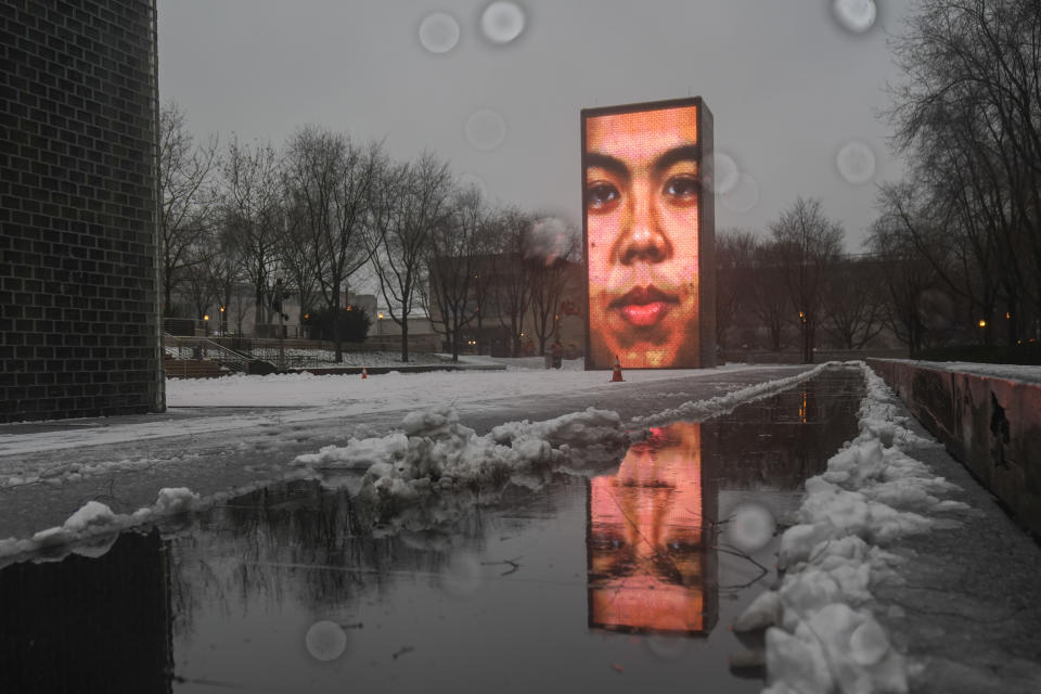 Snow falls on the Crown Fountain in Millennium Park during a winter storm, Friday, Jan. 12, 2024, in Chicago. (AP Photo/Erin Hooley)