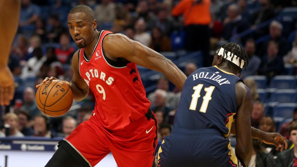 Nov 8, 2019; New Orleans, LA, USA; Toronto Raptors forward Serge Ibaka (9) drives around New Orleans Pelicans guard Jrue Holiday (11) in the first quarter at the Smoothie King Center. Mandatory Credit: Chuck Cook-USA TODAY Sports