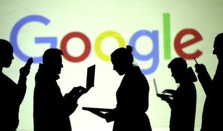 FILE PHOTO: Silhouettes of laptop and mobile device users are seen next to a screen projection of Google logo in this picture illustration taken March 28, 2018. REUTERS/Dado Ruvic/Illustration - RC1F87EA23D0/File Photo