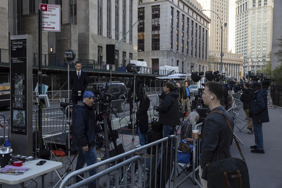 Members of the media gather outside Manhattan Criminal Court, Tuesday, April 16, 2024, in New York. Former President Donald Trump will return to court as a judge works to find a panel of jurors who will decide whether the former president is guilty of criminal charges alleging he falsified business records to cover up a sex scandal during the 2016 campaign. (AP Photo/Yuki Iwamura)