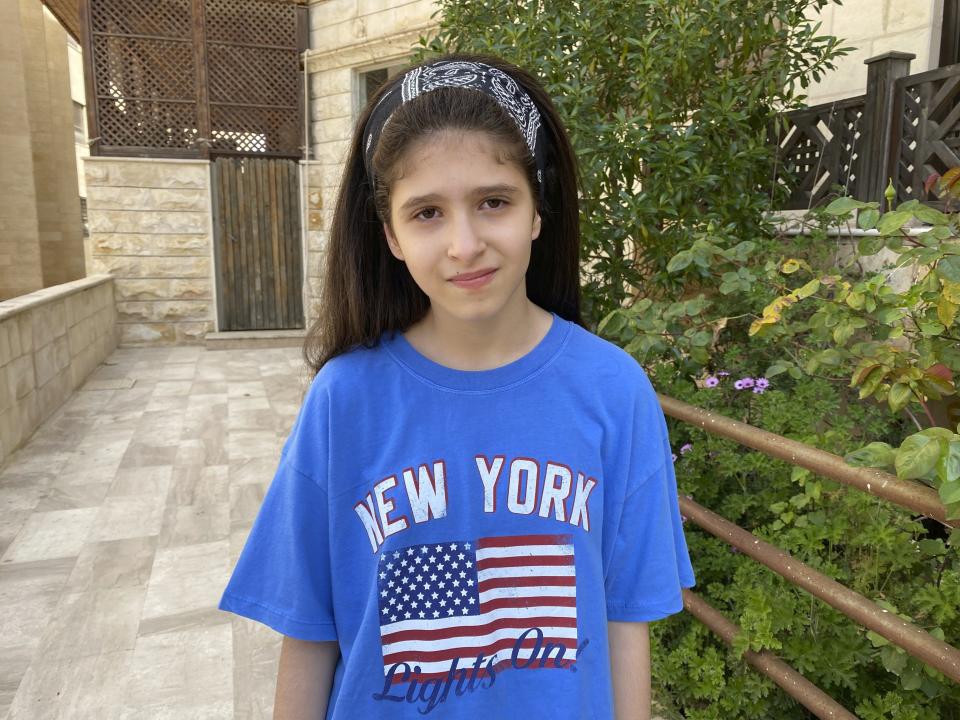 Baneen Ahmed stands for a portrait during the COVID-19 coronavirus lockdown in Amman, Jordan on April 15, 2020. Her family’s suffering in war-time Iraq has taught the 10-year old that outside events can turn life upside down in an instant. In the chaotic aftermath of the 2003 U.S.-led invasion of Iraq, an uncle was kidnapped, and a great-uncle was killed by armed militias, forcing her family to seek refuge in Jordan. (AP Photo/Omar Akour)