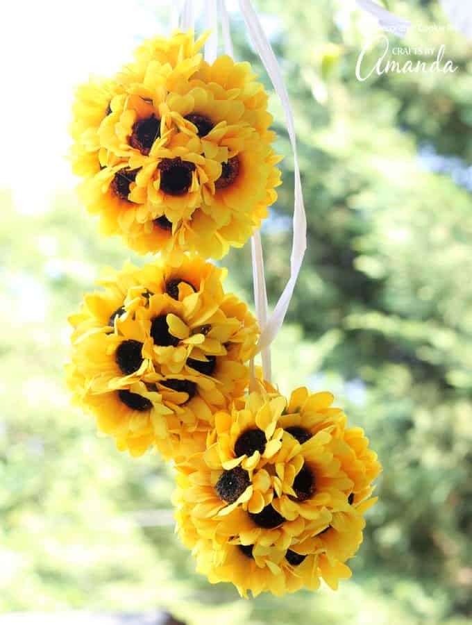 three hanging sunflower balls in the sunlight