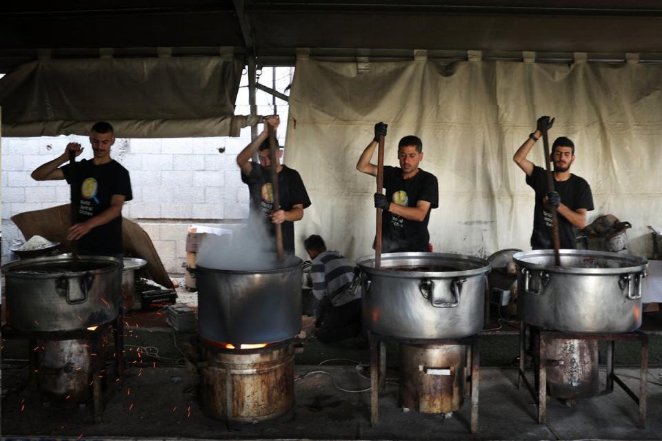 Volunteers from the World Central Kitchen cook meals to be distributed to needy Palestinians in Rafah (AFP via Getty Images)