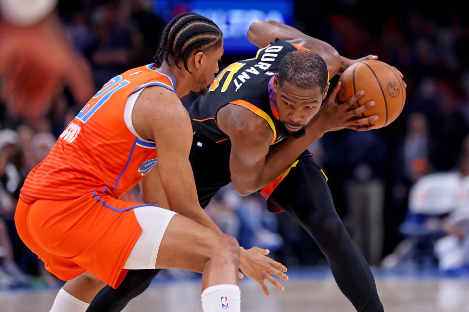 Phoenix Suns' Kevin Durant (35) looks to get by Oklahoma City Thunder's Aaron Wiggins (21) during the NBA basketball between the Oklahoma City Thunder and the Phoenix Suns at Paycom Center in Oklahoma City, Friday, March 29, 2024.