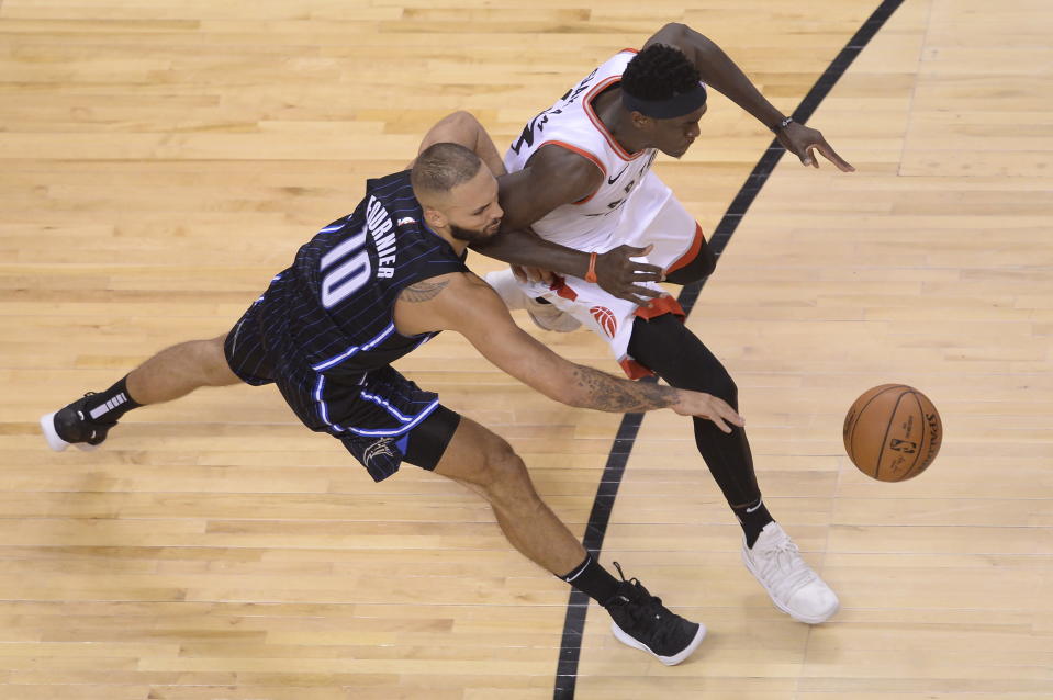 Toronto Raptors forward Pascal Siakam (43) steals the ball from Orlando Magic guard Evan Fournier (10) and then scores on a dunk during the second half in Game 1 of a first-round NBA basketball playoff series in Toronto, Saturday, April 13, 2019. (Nathan Denette/The Canadian Press via AP)