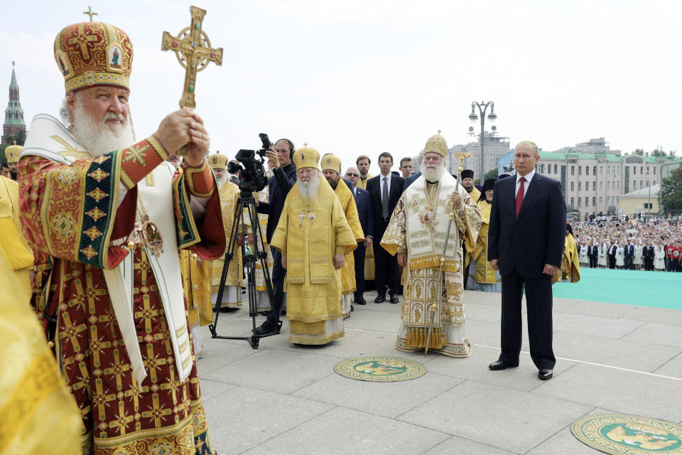 FILE - In this Saturday, July 28, 2018 file photo, Russian Orthodox Church Patriarch Kirill, left, leads a religious service as Russian President Vladimir Putin, right, and Eastern Orthodox Patriarch of Alexandria and all Africa Theodoros II, second right, attend a ceremony marking the 1,030th anniversary of the adoption of Christianity by Prince Vladimir, the leader of Kievan Rus. The loose federation of Slavic tribes preceded the Russian state. (Mikhail Klimentyev, Sputnik, Kremlin Pool Photo via AP, File)