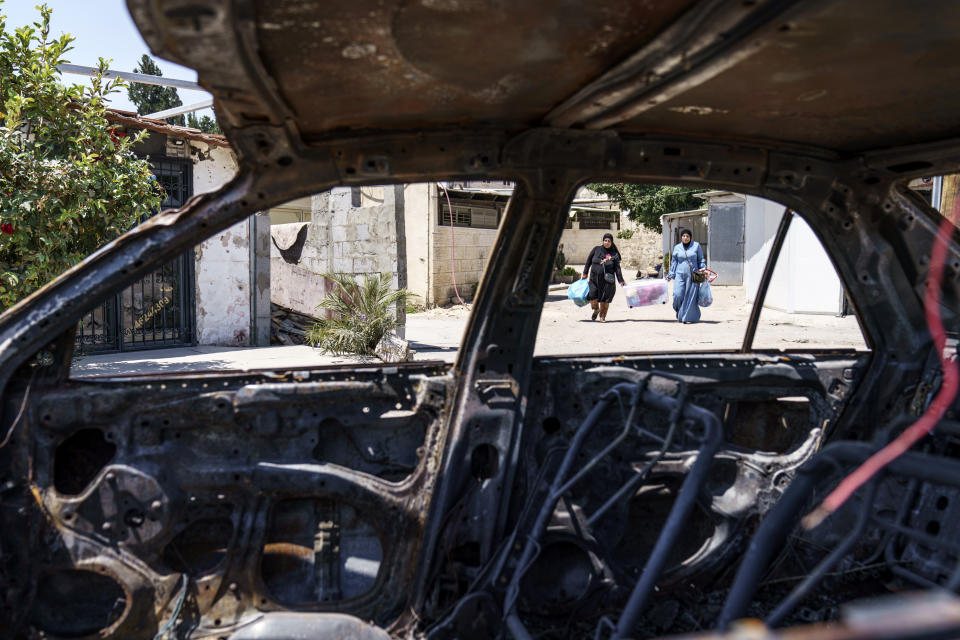 A car belonging to an Arab family sits torched from recent clashes between Arabs, police and Jews in the mixed Arab-Jewish town of Lod, central Israel, Tuesday, May 25, 2021. For more than a week, Lod was placed under a state of emergency as violence spiraled out of control. (AP Photo/David Goldman)