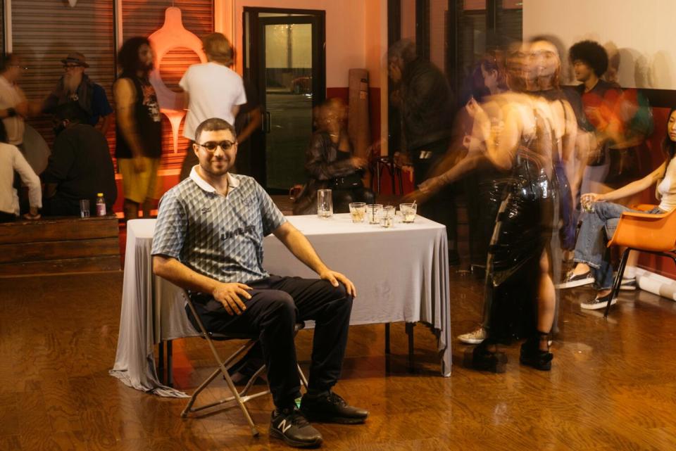 A man sits near a table.