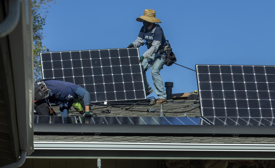 Workers installing solar panels