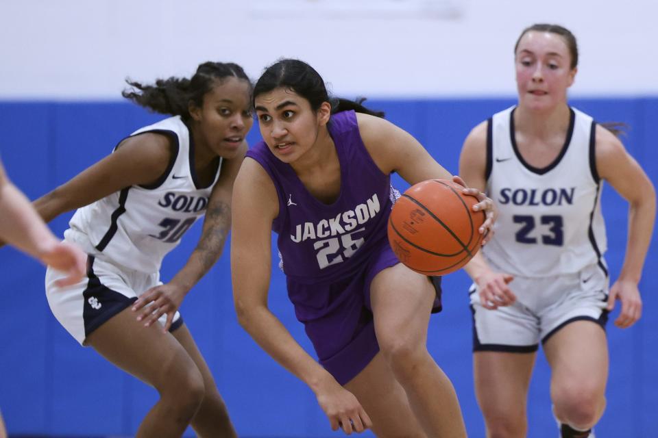 Jackson senior Leena Patibandla cuts between two defenders during the Division I district final against Solon, Friday, Feb. 24, 2023, at Ravenna High School.