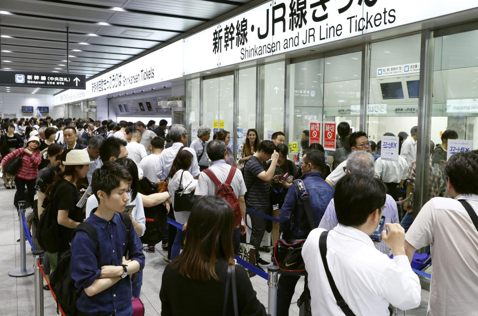 <p>People stand in lines to buy tickets when Shinkansen bullet train service was resumed at Shin-Osaka train station in Osaka, western Japan, Monday, June 18, 2018. (Photo: Meika Fujio/Kyodo News via AP) </p>