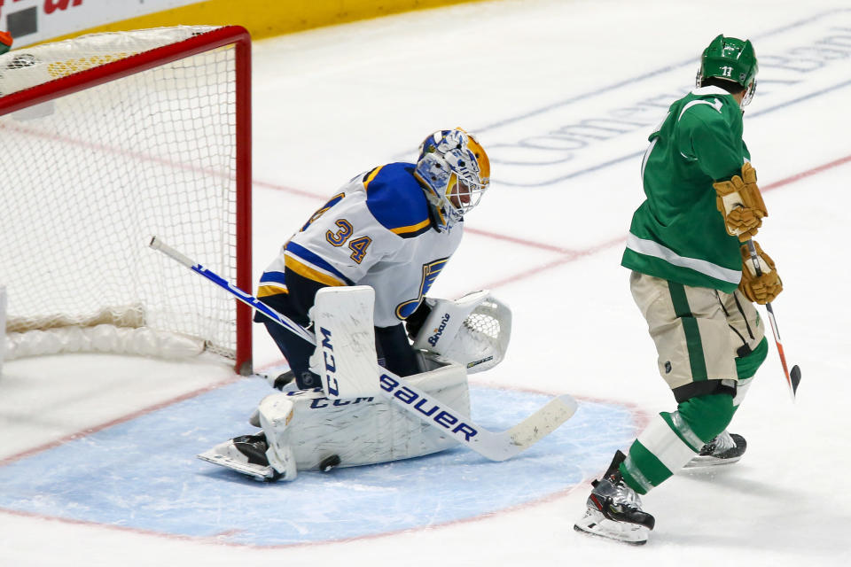St. Louis Blues goaltender Jake Allen, left, makes a pad save on the shot by Dallas Stars center Andrew Cogliano, right, during the third period of an NHL hockey game in Dallas, Friday, Feb. 21, 2020. The Blues won 5-1. (AP Photo/Ray Carlin)