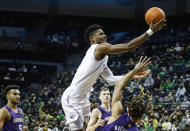 Oregon forward Quincy Guerrier, top, shoots over Washington forward Emmitt Matthews Jr., right, in the first half of an NCAA college basketball game in Eugene, Ore., Sunday, Jan. 23, 2022. (AP Photo/Thomas Boyd)