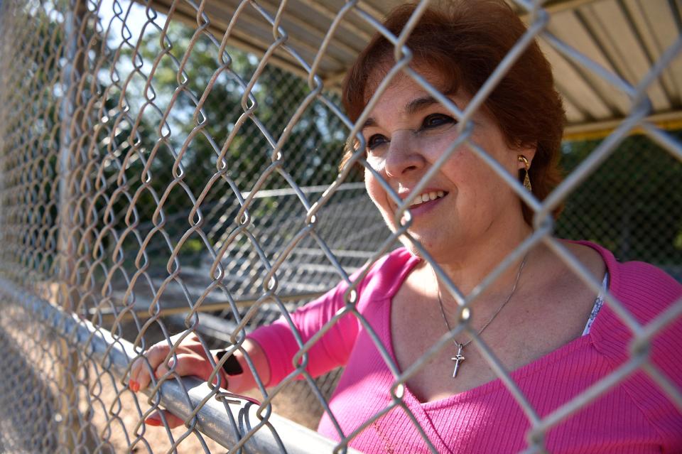 René Testa Adams, of Hawthorne, suffered a stroke when she was coaching a softball game on Wagaraw Road in April 1989. Here, she looks out from the dugout of the same field where the health emergency occurred.