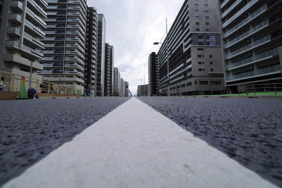 FILE - In this June 20, 2021, file photo, a road at the Tokyo 2020 Olympic and Paralympic Village is seen, in Tokyo. The Tokyo Olympics are not looking like much fun: Not for athletes. Not for fans. And not for the Japanese public, who are caught between concerns about the coronavirus at a time when few are vaccinated on one side and politicians and the International Olympic Committee who are pressing ahead on the other. (AP Photo/Eugene Hoshiko, File)