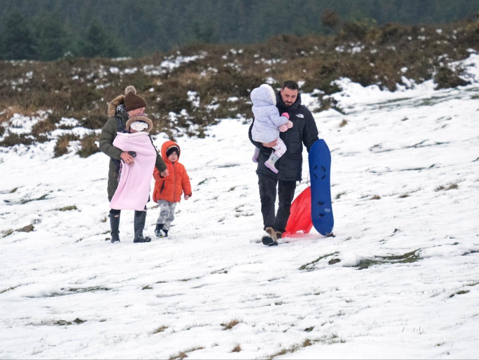 A family make use of the spring snow on Dartmoor to go sledging (Matt Keeble/PA Wire)