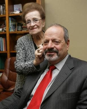 Rhoberta Leeser stands by her son, Oscar Leeser, in this Dec. 24, 2010, file photo.