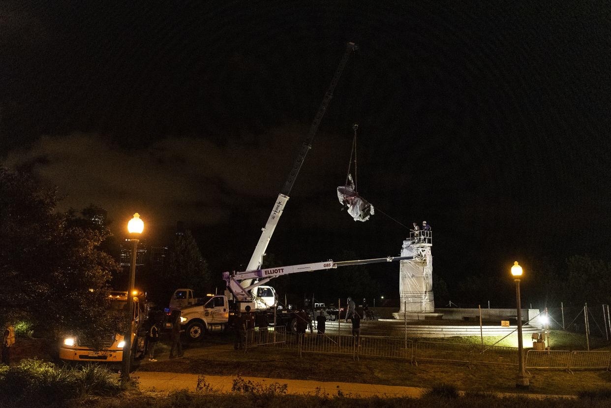 A crane removes the Christopher Columbus statue in Grant Park from its plinth on July 24, 2020 in Chicago.