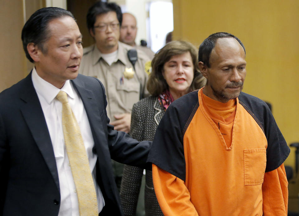 FILE - Jose Ines Garcia Zarate, right, is led into the courtroom by San Francisco Public Defender Jeff Adachi, left, and Assistant District Attorney Diana Garciaor, center, for his arraignment in San Francisco, July 7, 2015. A California federal judge on Monday, June 6, 2022, sentenced the Mexican national who shot a woman along a San Francisco pier to the seven years he's already spent in jail. The sentence brings to a legal close a tragedy that ignited a national firestorm over immigration, crime and sanctuary cities such as San Francisco. (Michael Macor/San Francisco Chronicle via AP, Pool, File)