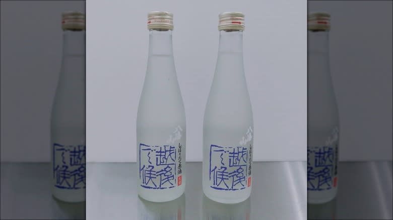 Two Hakkaisan sake bottles side by side