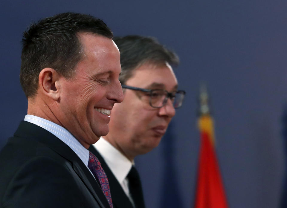 U.S. President Donald Trump's envoy for the Kosovo-Serbia dialogue, Ambassador Richard Grenell, left, and Serbian President Aleksandar Vucic arrive for a news conference after their meeting in Belgrade, Serbia, Friday, Jan. 24, 2020. Grenell is meeting Serbian President Vucic in order to move the dialogue and normalize relations between the two sides.(AP Photo/Darko Vojinovic)