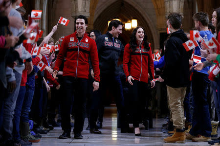 Ice dancers Tessa Virtue and Scott Moir greet school children with Canada's Prime Minister Justin Trudeau before being named Canada's flag-bearers for the opening ceremony of the 2018 Pyeongchang Winter Olympic Games during an event on Parliament Hill in Ottawa, Ontario, Canada, January 16, 2018. REUTERS/Chris Wattie