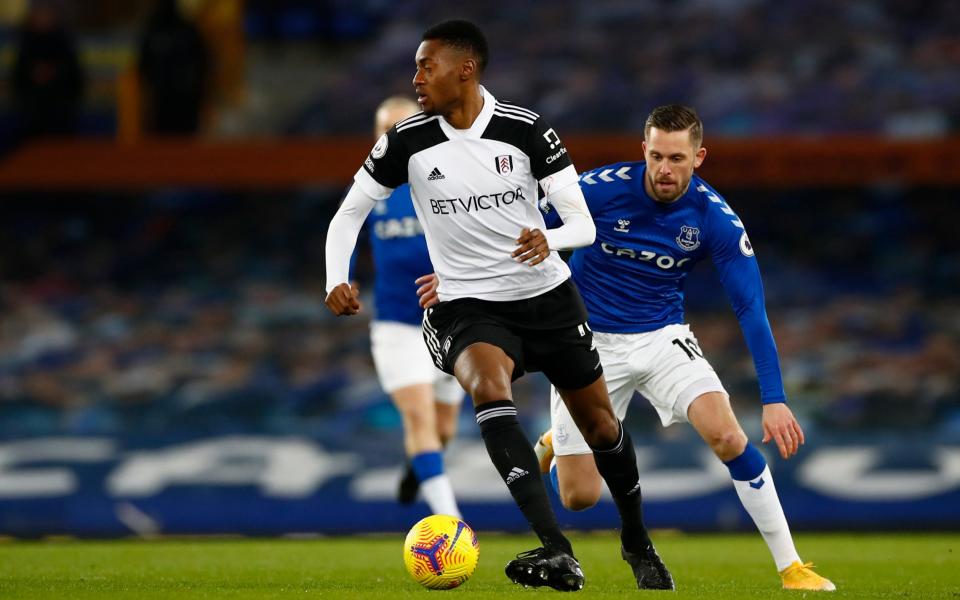 Fulham's Tosin Adarabioyo, left, duels for the ball with Everton's Gylfi Sigurdsson during the English Premier League soccer match between Everton and Fulham at Goodison Park in Liverpool, England, Sunday, Feb. 14, 2021. - AP