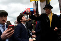 A bookmaker takes bets from punters at Fairyhouse Racecourse in Ratoath, Ireland, April 17, 2017. REUTERS/Clodagh Kilcoyne