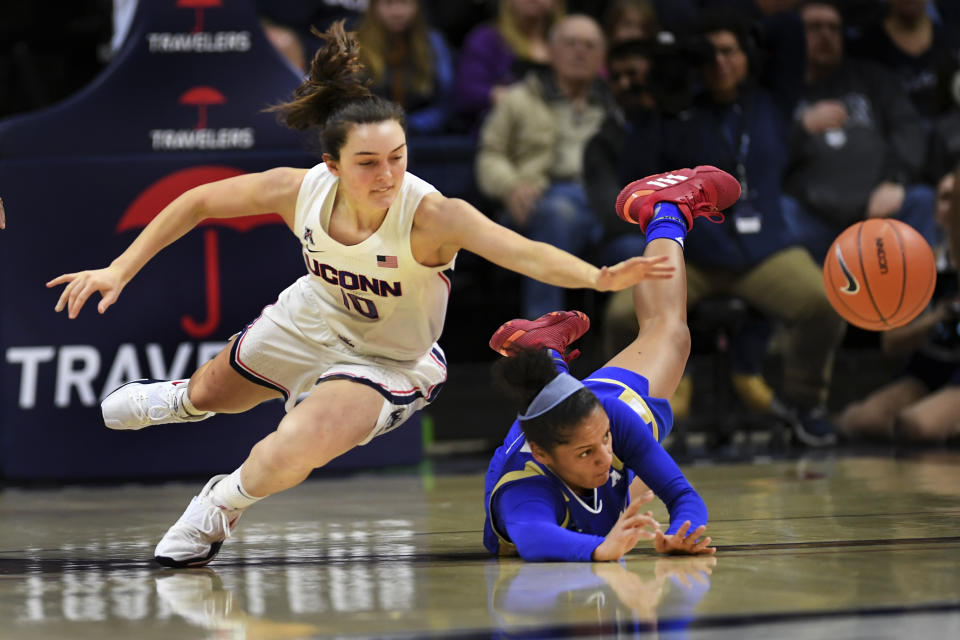 Connecticut's Molly Bent (10) goes for the ball against Tulsa's Rebecca Lescay (21) during the first half of an NCAA college basketball game Sunday, Jan.19, 2020, in Storrs, Conn. (AP Photo/Stephen Dunn)