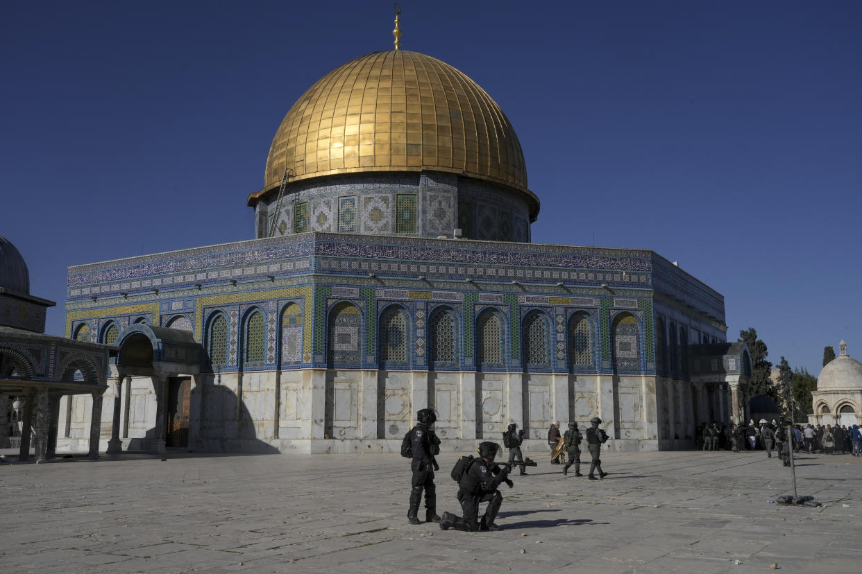 Israeli security forces take position during clashes with Palestinians demonstrators in front of the Dome of the Rock shrine at the Al Aqsa Mosque compound in Jerusalem's Old City, Friday, April 15, 2022. (AP Photo/Mahmoud Illean)