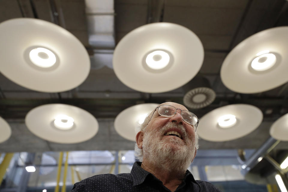 Swiss scientist Michel Mayor talk to journalists after landing at the Barajas airport in Madrid, Tuesday, Oct. 8, 2019. Mayor has been jointly awarded the 2019 Nobel Prize in Physics along with Professor Didier Queloz and Professor James Peebles for their pioneering advances in physical cosmology, and the discovery of an exoplanet orbiting a solar-type star. (AP Photo/Manu Fernandez)