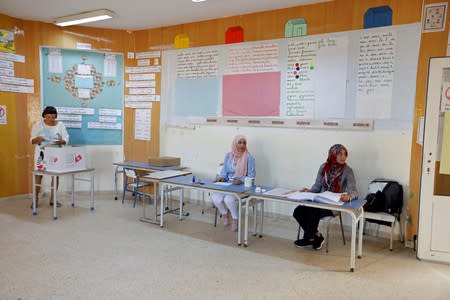 Electoral members are seen in a polling station during a second round runoff of a presidential election in Tunis