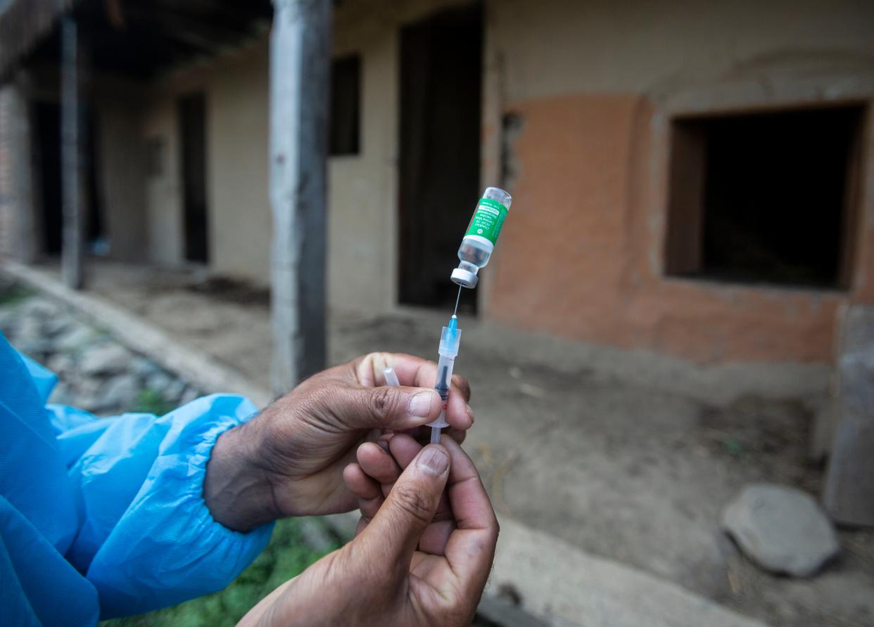 A health worker prepares to administer a Covid-19 vaccine in a village north of Srinagar,  India on 10 June, 2021. (AP)
