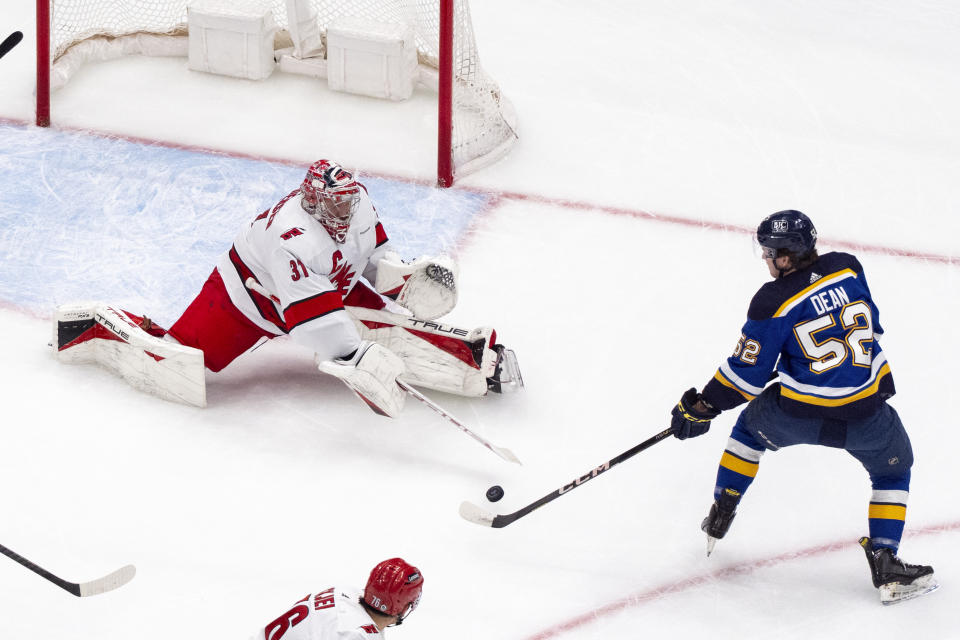 St. Louis Blues' Zach Dean (52) is unable to score past Carolina Hurricanes goaltender Frederik Andersen during the first period of an NHL hockey game Friday, April 12, 2024, in St. Louis. (AP Photo/Jeff Roberson)