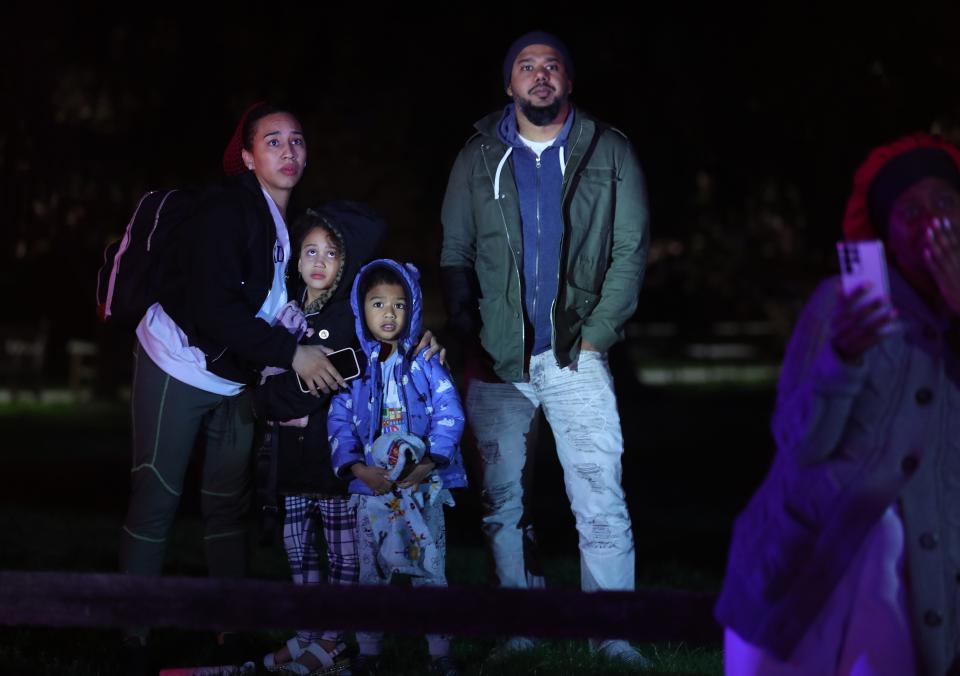 A family that was forced to flee the fire watches from across the street as White Plains firefighters battle a blaze in an apartment building at 11 Lake Street  in White Plains April 18, 2023. The fire broke out shortly after midnight, injuring  several residents and leaving dozens homeless.