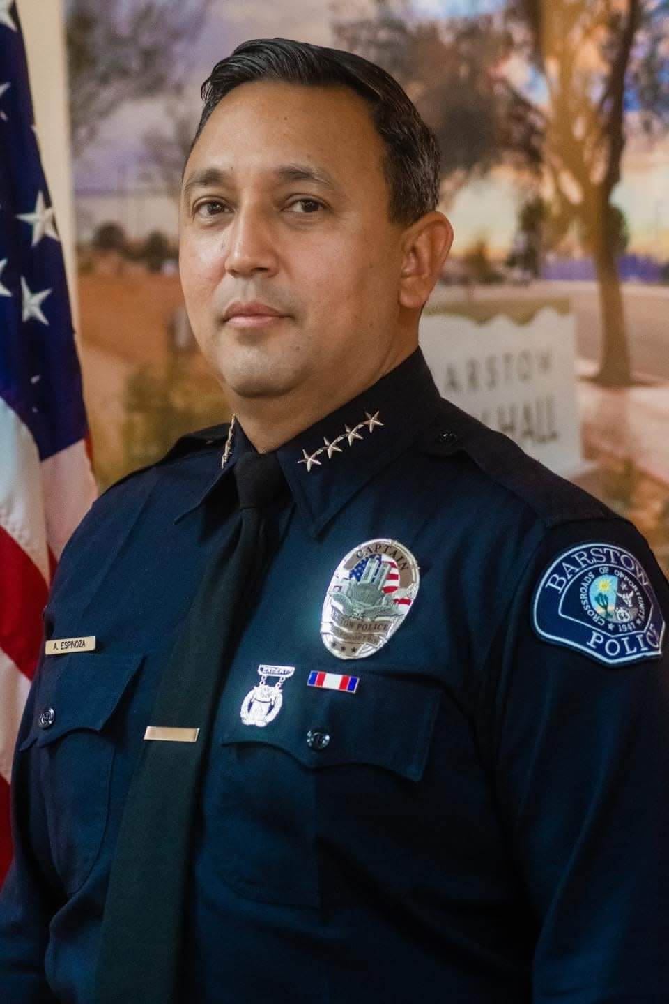 Barstow Police Chief Andrew Espinoza, Jr, pictured, said one of his officers has been placed on administrative leave as police officials investigate his use of a baton on an uncooperative suspect.