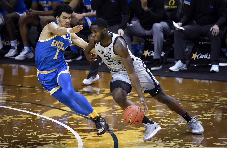 UCLA guard Jules Bernard (1) defends against Oregon forward Eugene Omoruyi (2) during the first half of an NCAA college basketball game Wednesday, March 3, 2021, in Eugene, Ore. (AP Photo/Andy Nelson)