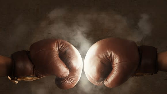 Two boxing gloves hitting each other