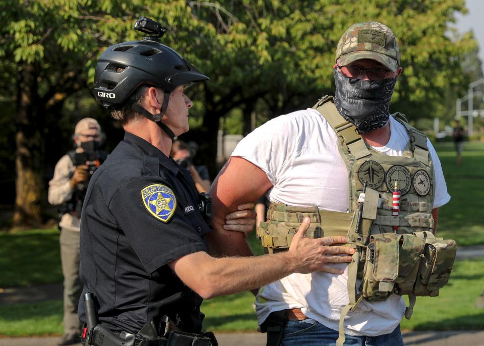 A right-wing demonstrator is arrested by Salem Police during an American Lives Matter, pro-Trump rally at the Oregon State Capitol in Salem, Oregon on Monday, Sept. 7, 2020. 